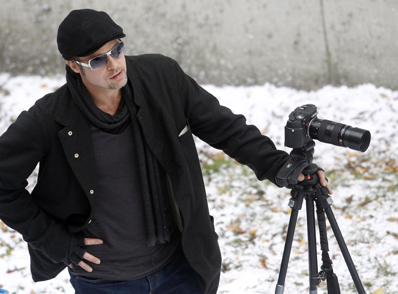 Actor Brad Pitt stands next to a camera on the set of actress Angelina Jolie's yet untitled directorial debut in Budapest November 8, 2010. Jolie is directing her first feature film about a Serbian man and Bosnian woman who meet on the eve of the 1992-95 Bosnian war. REUTERS/Laszlo Balogh (HUNGARY - Tags: ENTERTAINMENT)