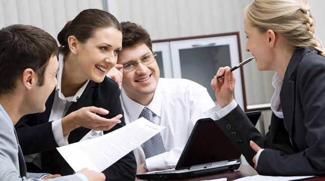 Portrait of happy business team interacting in the office