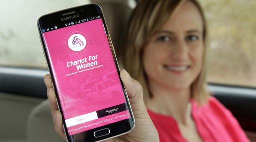 In this Thursday, April 7, 2016 photo Kelly Pelletz, of Charlton, Mass., co-creator of the ride-sharing service Chariot for Women, displays the app on a mobile phone, in Charlton. Kelly and her husband Michael Pelletz are launching the service this summer, featuring female drivers picking up solely women and children passengers. (AP Photo/Steven Senne)