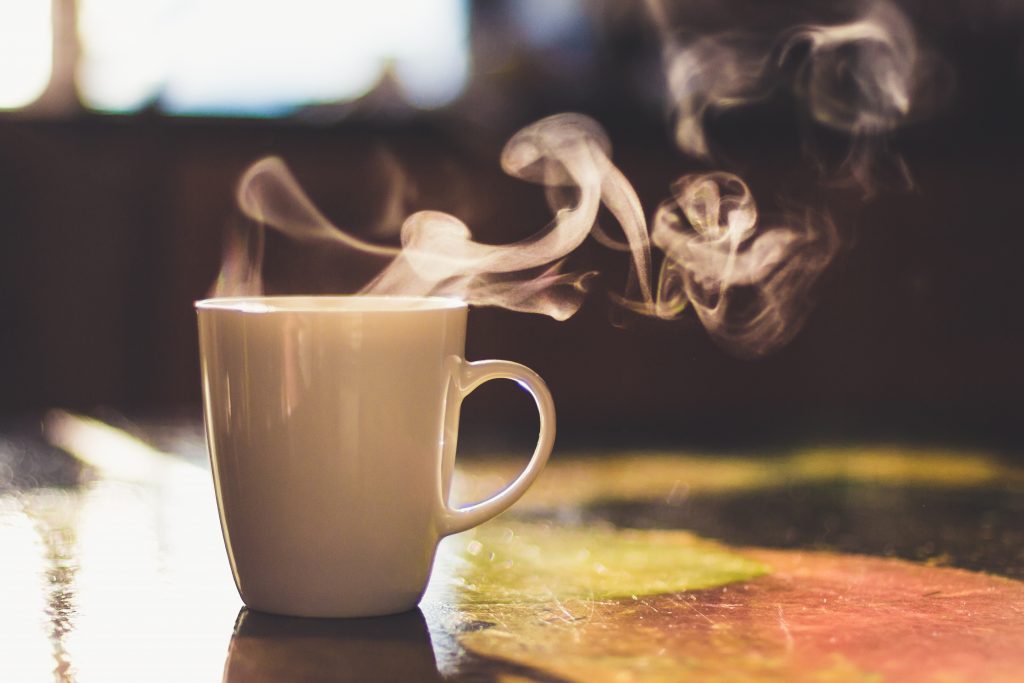 Close Up Of Steaming Cup Of Coffee Or Tea On Vintage Table   Early Morning Breakfast On Rustic Background