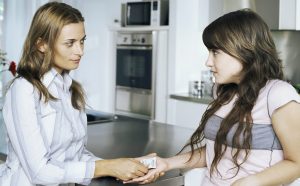 Mother Giving Condom To Daughter