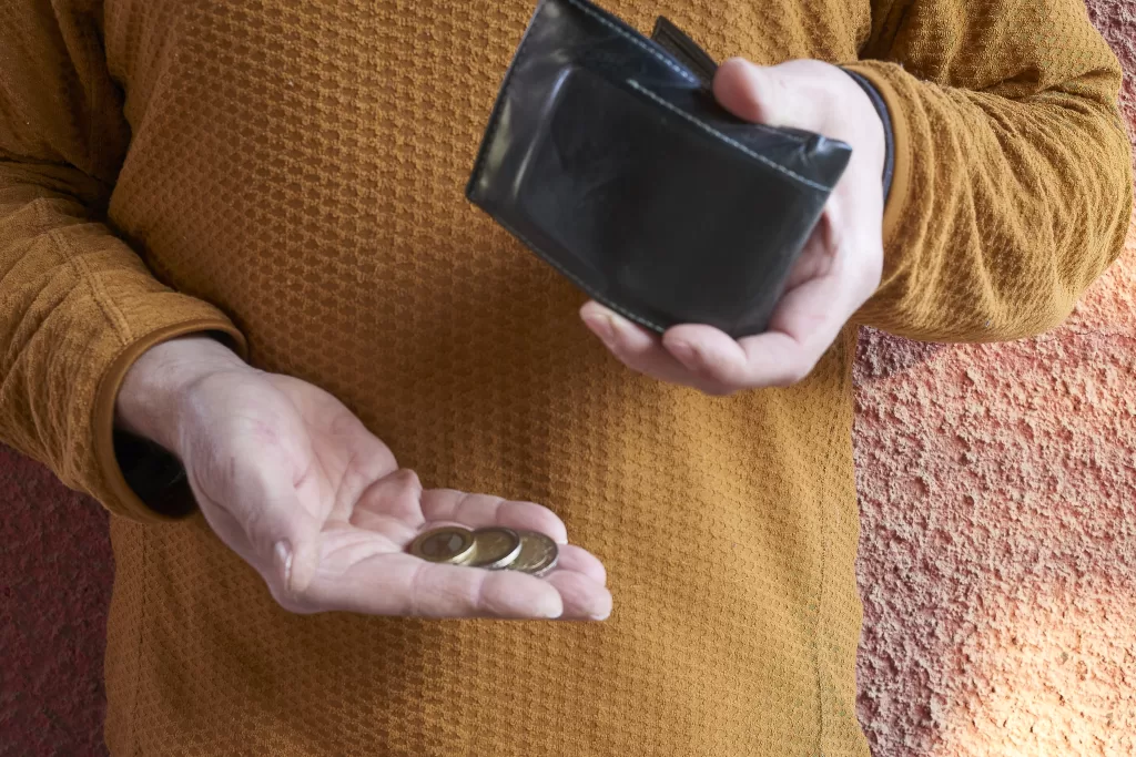 A Person Holds Some Coins In His Hand