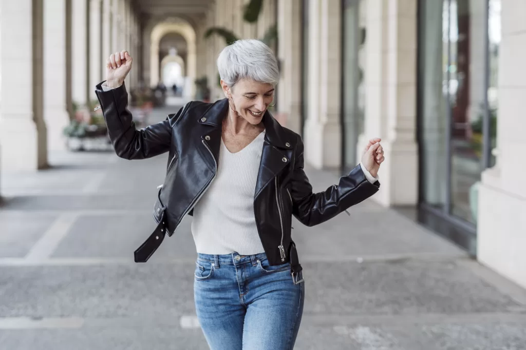 Cheerful And Happy Mature Woman Dancing In The Middle Of The Street. Happiness Concept.